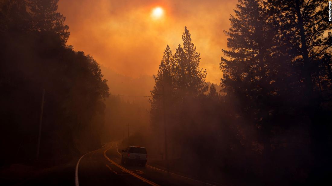 A vehicle drives through smoke near Pulga on Sunday, November 11.