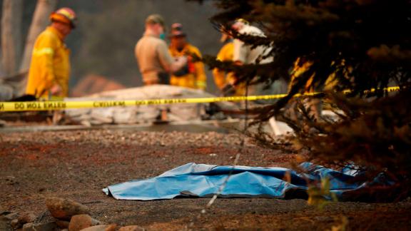 A bag containing human remains lies on the ground on November 11 as officials continue to search for victims at a burned-out home in Paradise.