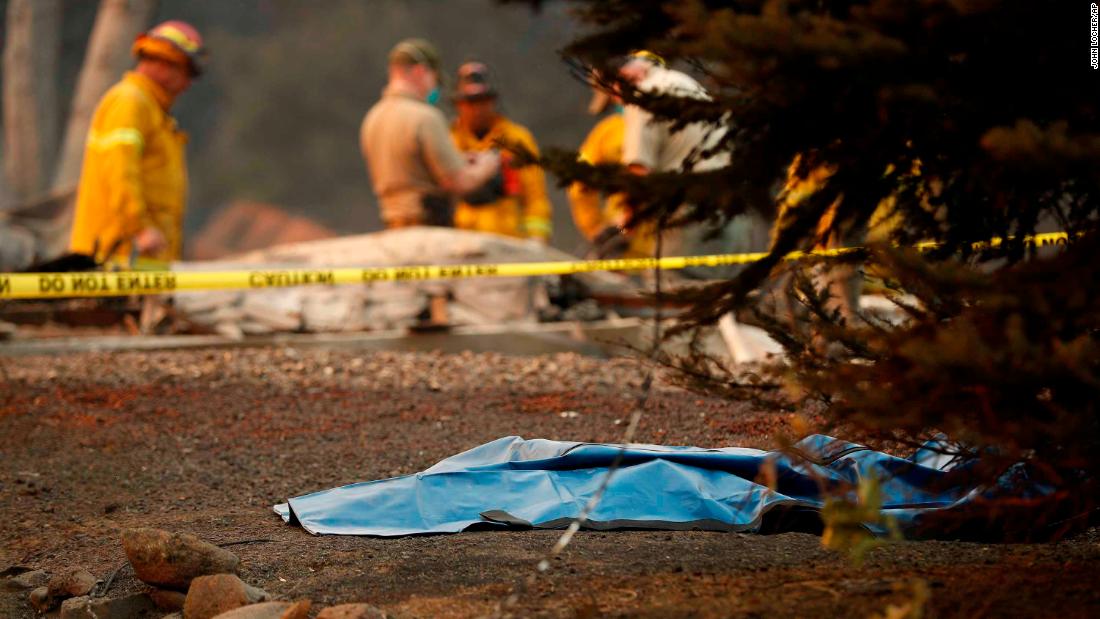 A bag containing human remains lies on the ground on November 11 as officials continue to search for victims at a burned-out home in Paradise.