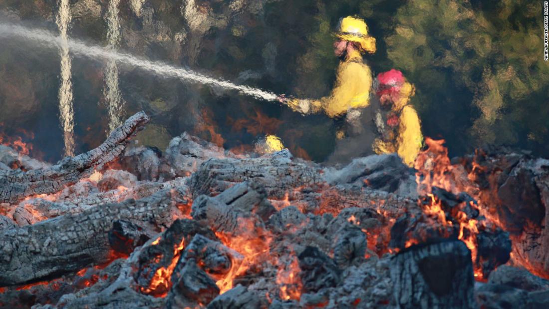 Firefighters work at the Salvation Army Camp in Malibu on Saturday, November 10.