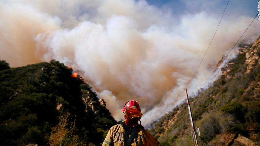 Firefighters battle the Woolsey Fire in Malibu on November 11.