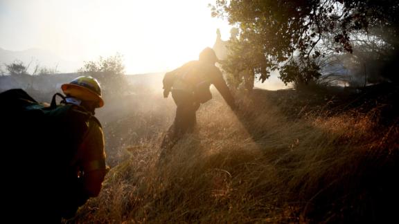 Firefighters battle a blaze in Malibu on Saturday, November 10.