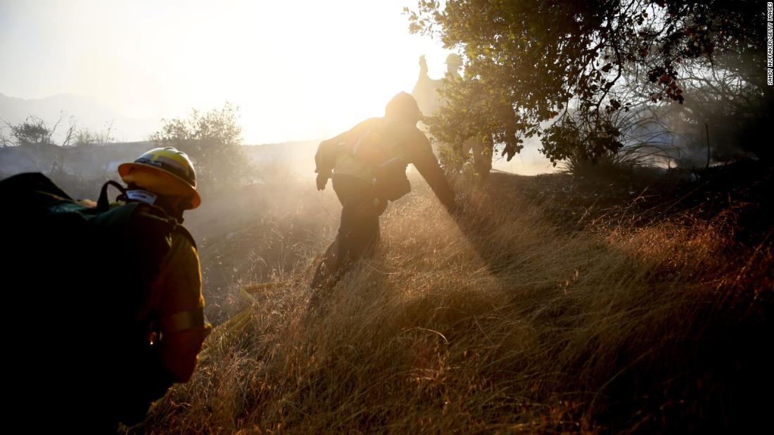 Firefighters battle a blaze in Malibu on Saturday, November 10.