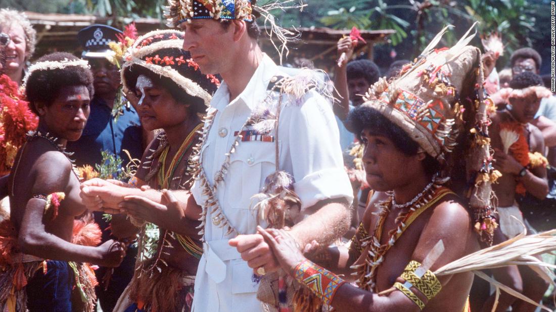 Charles walks with natives on a visit to Papua New Guinea in 1984. 