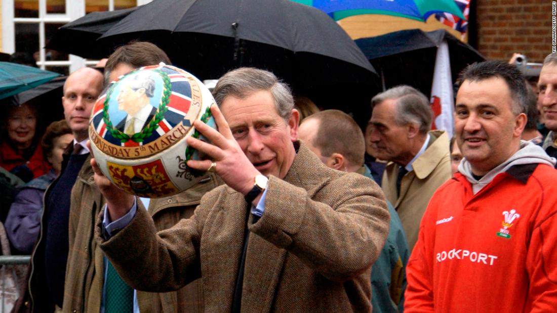 Charles carries a specially painted football through the streets of Ashbourne, England, in March 2003.