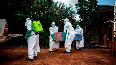 Health workers carry the body of a patient with unconfirmed Ebola virus on August 22, 2018, in the Democratic Republic of Congo.
