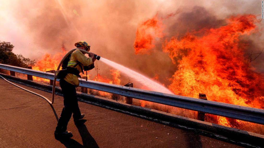 A firefighter battles a fire in Simi Valley on November 12.