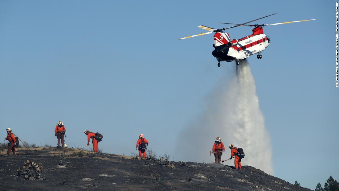 Firefighters put out hot spots in Thousand Oaks on November 12.