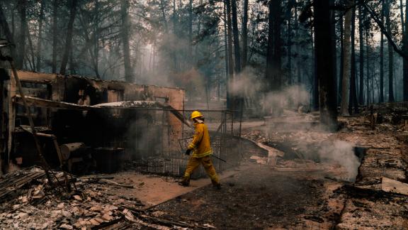 Firefighters put out hot spots in Paradise on November 12.
