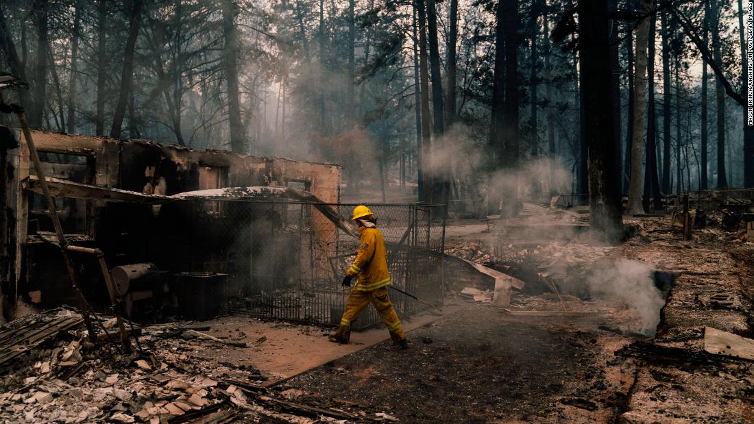 Firefighters put out hot spots in Paradise on November 12.