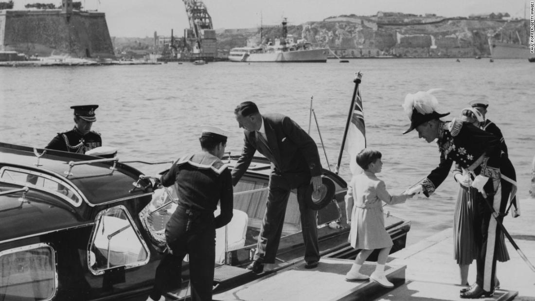 Charles, right, shakes hands with Sir Gerald Creasy, the governor of Malta, as he and the rest of the royal family visit Malta in May 1954.