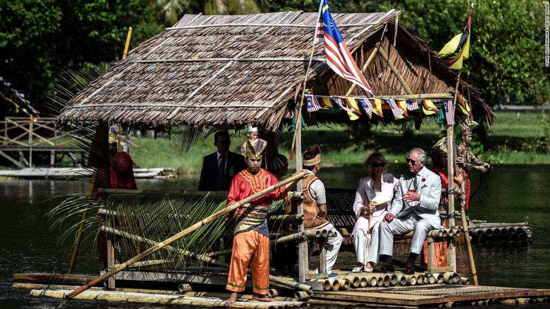Charles and Camilla ride on a raft while visiting the island of Borneo in November 2017.