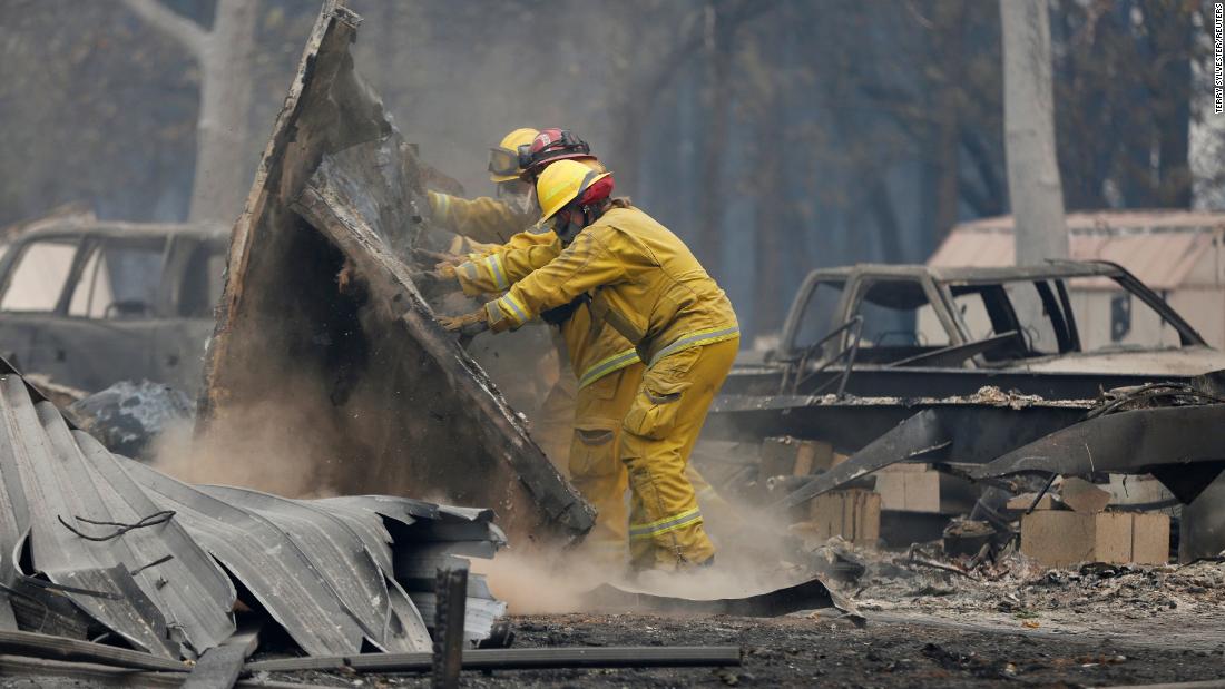 Firefighters search through the remains of a Paradise house on November 13.