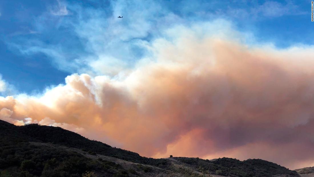 Smoke fills the horizon on November 13 as an airplane flies near a flare-up of the Woolsey Fire near Lake Sherwood.