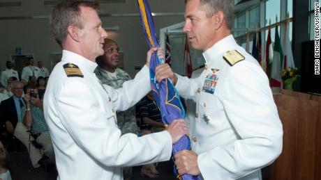 U.S. Navy Rear Adm. Scott Stearney, commander of the Joint Enabling Capabilities Command, (right) passes the Joint Public Affairs Support Element colors to the incoming commander, U.S. Navy Capt. Jeffrey Breslau in 2012.