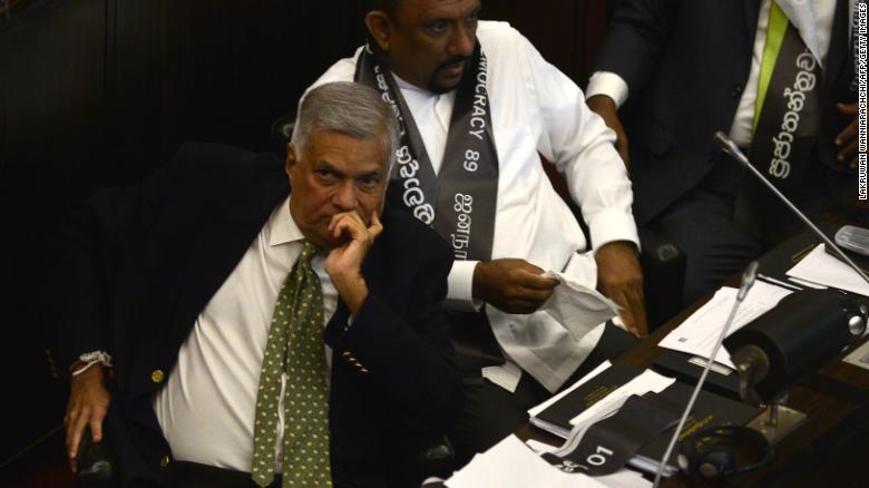Sri Lanka&#39;s ousted prime minister Ranil Wickremesinghe (L) looks on during Wednesday&#39;s  parliamentary session, November 14, 2018. 