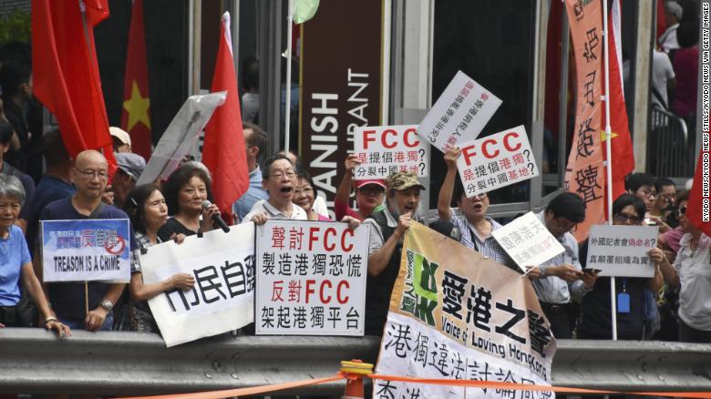 People raise pro-China signs in a protest against Hong Kong independence in front of the Foreign Correspondents&#39; Club in Hong Kong on August 14, 2018. 