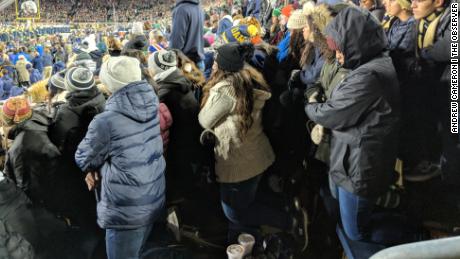 Notre Dame students kneel as the National Anthem plays during a November 10, 2018, football game.