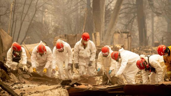 Rescue workers sift through rubble in search of human remains on Wednesday, November 14, at a burned property in Paradise.