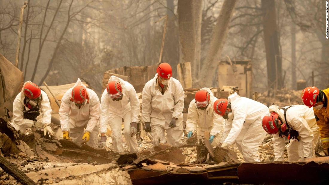 Rescue workers sift through rubble in search of human remains on Wednesday, November 14, at a burned property in Paradise.