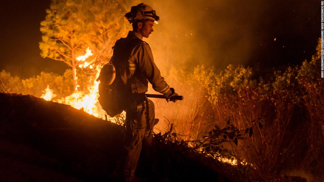 Firefighters work to control the Camp Fire on November 14 north of Oroville, California.