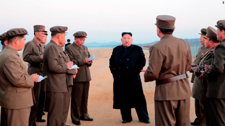 In this undated photo released on Friday by the North Korean government, Kim Jong Un, listens to a military official as he inspects a weapon testing.