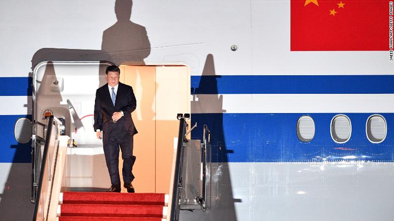 China's President Xi Jinping walks down the stairs of his plane upon arrival at Port Moresby International Airport on November 15.