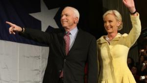 Republican presidential candidate US Senator John McCain (R-AZ) and his wife Cindy wave to supporters after securing the GOP nomination on March 4, 2008 in Dallas, Texas.  McCain seized the Republicans' White House mantle with a promise to defeat Islamic extremism and keep the US economy open to world trade if elected president in November.  AFP PHOTO / TIMOTHY A. CLARY (Photo by TIMOTHY A. CLARY / AFP)        (Photo credit should read TIMOTHY A. CLARY/AFP/Getty Images)