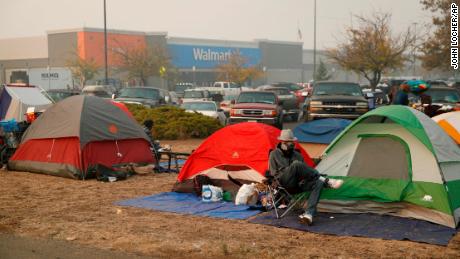 Fire drove them out of their homes. Now they could be flooded out of their tent city.