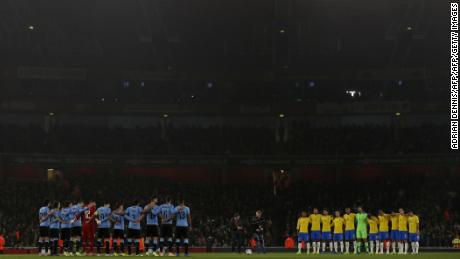 Uruguay and Brazil players honor Schlee with a minute&#39;s silence ahead of an international friendly in London on Friday.