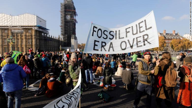 Demonstrators take part in a pro-environment protest as they block Westminster Bridge, near parliament.