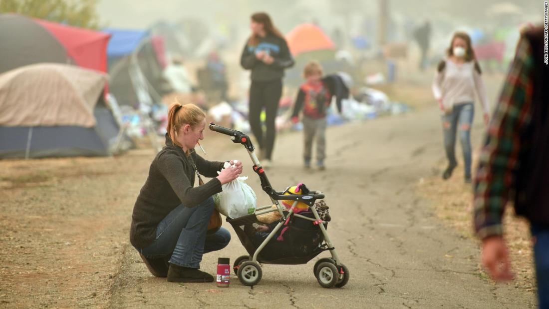 Ashley Sheppard, whose house burned down, tends to her baby on November 15.