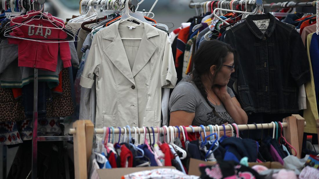 An evacuee looks through donated clothing at the makeshift evacuation shelter on November 16.