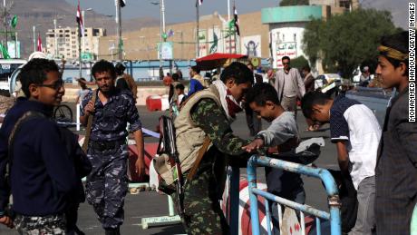 Houthi fighters check people entering a square for a rally last month in Sanaa.