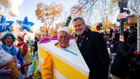 Bankruptcy lawyer Chuck Tatelbaum, seen here with New York City Mayor Bill de Blasio, has walked in the Macy's Thanksgivng Day parade since 2011.