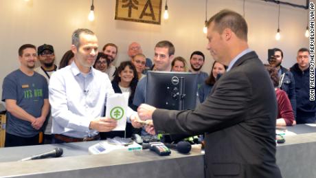 Arnon Vered sells Northampton Mayor David Narkewicz the first legal recreational marijuana at the NETA facility on Tuesday in Northampton.