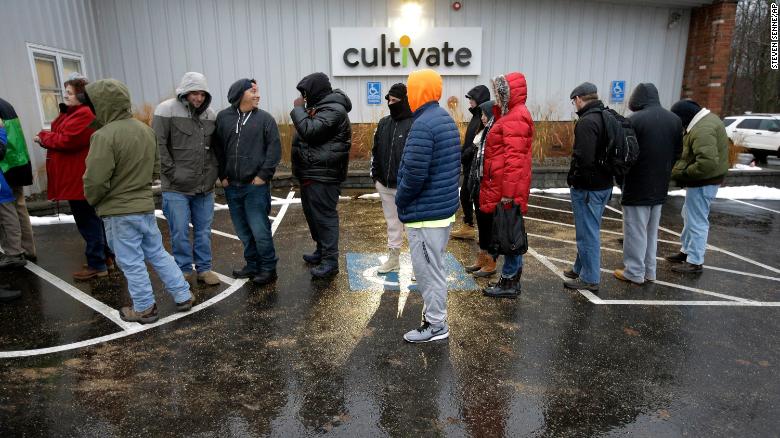 Customers wait outside the Cultivate Holdings dispensary Tuesday to purchase recreational marijuana on the first day of legal sales in Massachusetts.