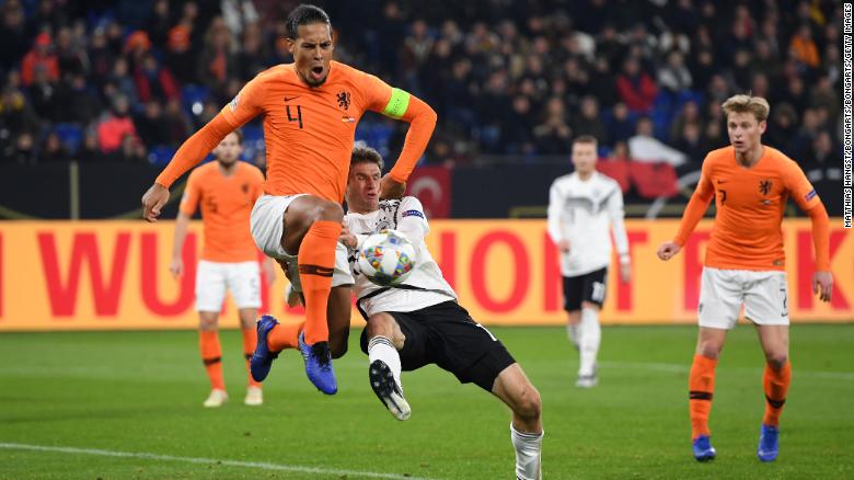 Dutch captain Virgil van Dijk battles for possession with Thomas Muller of Germany during their UEFA Nations League A1 match.