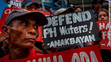 Demonstrators carry placards bearing anti-China slogans in a protest of Chinese influence in the Asia-Pacific sphere. 