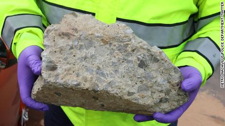 An investigator holds the block that killed the driver of a car in Nashville. 