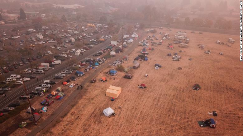 Evacuees from the Camp Fire shelter in tents outside the Walmart in Chico, California.