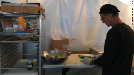 Michael Scoggins prepares dinner for residents and first responders at Camp Happy Tummies. His restaurant, Killer Seafood was complete destroyed in the storm. 