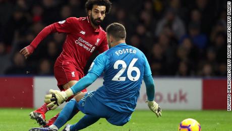 Liverpool's Mohamed Salah is challenged by Watford keeper Ben Foster during the EPL encounter at Vicarage Road in Watford.