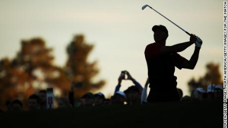 Tiger Woods plays his second shot on the 18th hole during The Match.