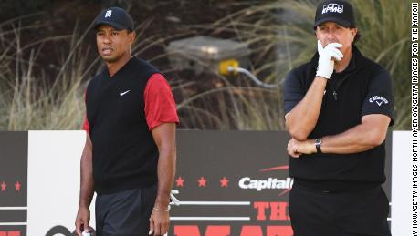 Woods and Mickelson look on from the seventh tee.