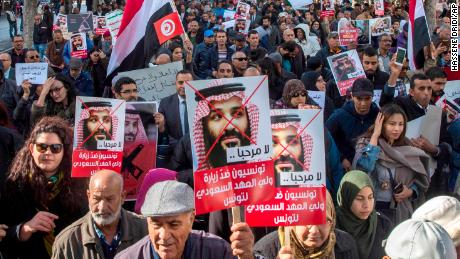 Tunisians demonstrate with placards reading 'You are not welcomed' and showing Saudi Crown Prince Mohammed bin Salman, Tuesday Nov.27, 2018 in Tunis. 