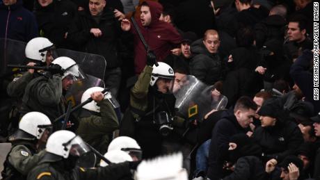 Police clash with Ajax fans at AEK's stadium in Athens. 