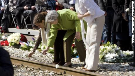 A Dutch Holocaust survivor lays flowers with her granddaughters at Westerbork in 2010 to mark the 65th anniversary of the liberation of the Dutch transit camp.