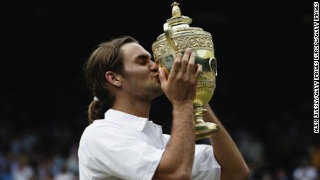 Roger Federer kisses the trophy after his victory over Mark Philippoussis of Australia in the Men&#39;s Singles Final during the final day of the Wimbledon Lawn Tennis Championships in 2003.