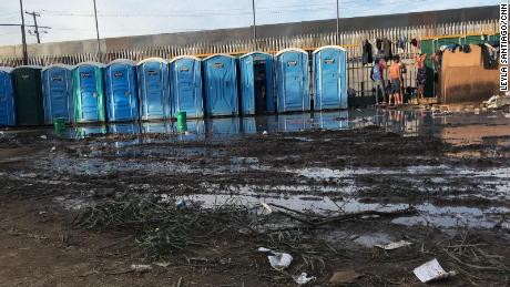 Runoff from showers and portable toilets leaves a nearby field muddy at the Benito Juarez Sports Complex in Tijuana, Mexico, where thousands of migrants have taken shelter as they wait to seek asylum in the United States.